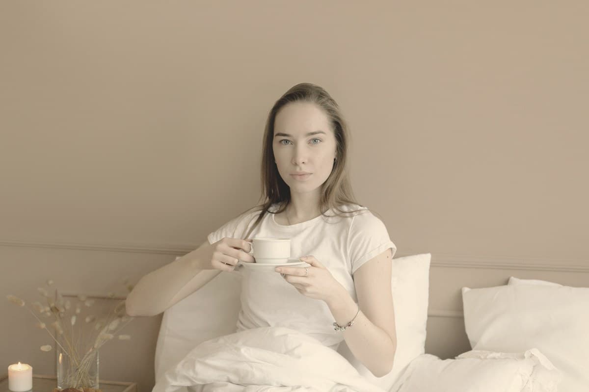 A woman in soft morning light against a plain neutral background, reflecting the quiet decision-making behind choosing a weight-loss injection.