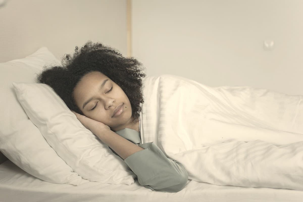 A person sleeping calmly in a softly lit bedroom, representing the obstructive sleep apnea indication added to Zepbound's FDA label.