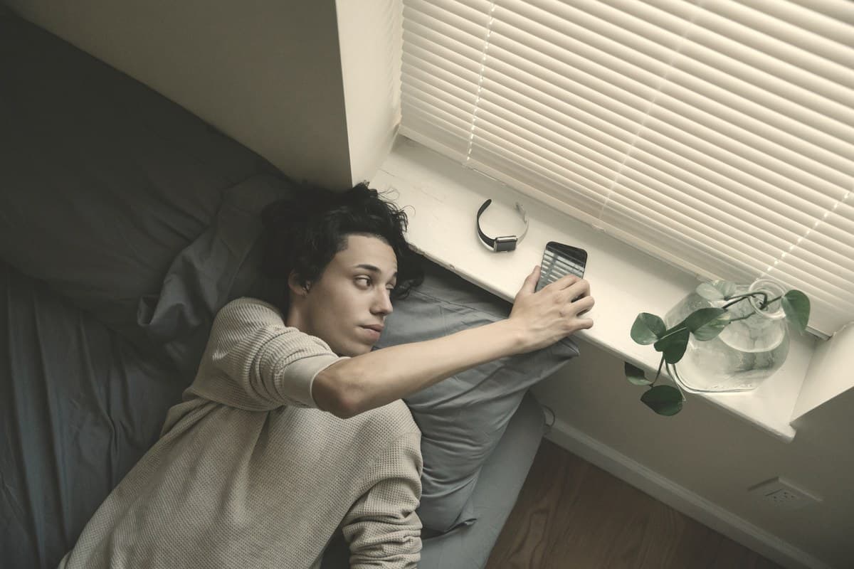 A person sitting quietly near a soft-lit window against a plain wall, reflecting the uncertainty around Mounjaro's long-term side effect profile beyond two-year trials.
