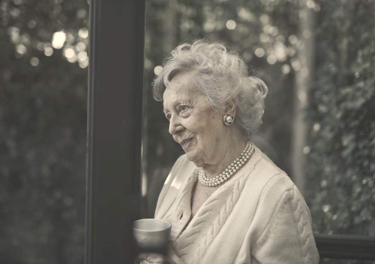 A calm older woman sitting near a window in soft daylight, representing Medicare-eligible patients navigating Wegovy coverage options