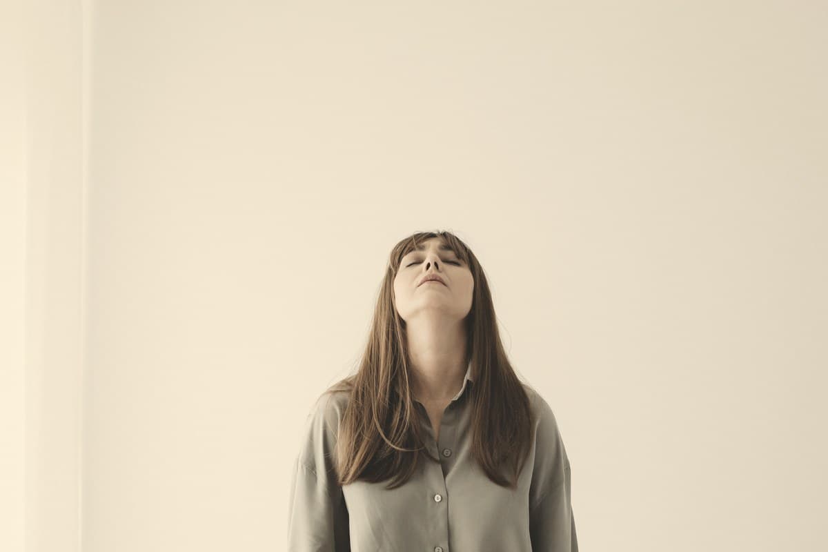 A woman in soft morning light against a neutral background, reflecting the quiet lifestyle context of lipotropic injection ingredients and their modest effects.
