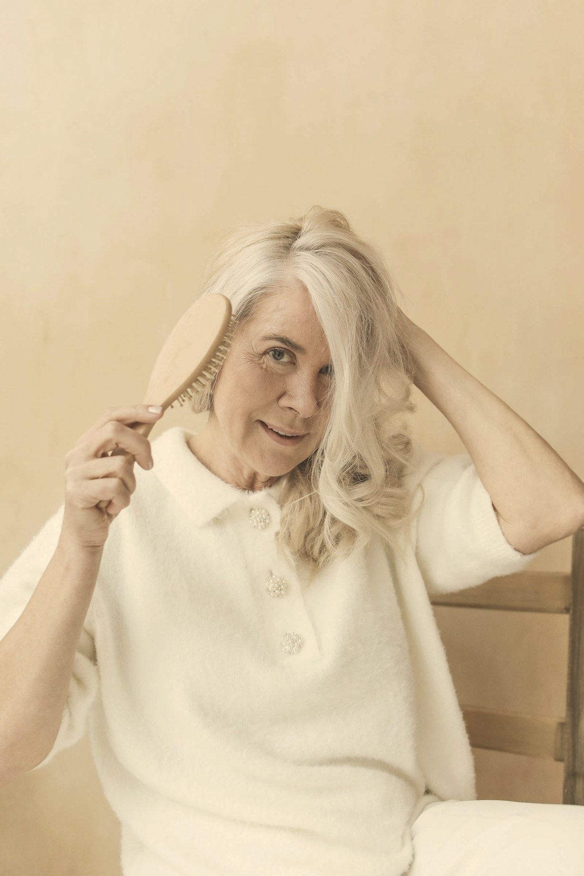 Woman brushing her hair — GLP-1 hair loss is usually telogen effluvium triggered by rapid weight loss, and it disproportionately affects women