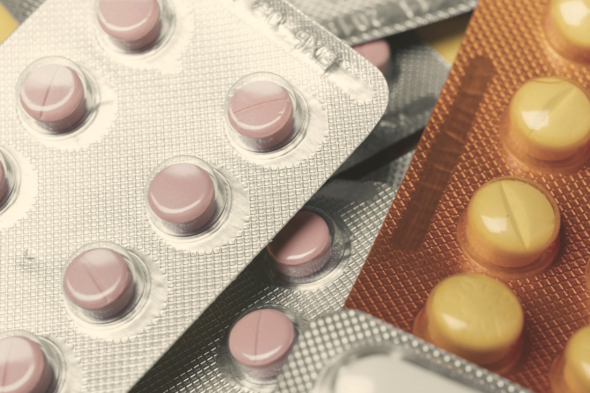 Oral medication tablets in blister packs — a GLP-1's gastric-emptying delay can make oral HRT absorption more variable, which favors transdermal delivery
