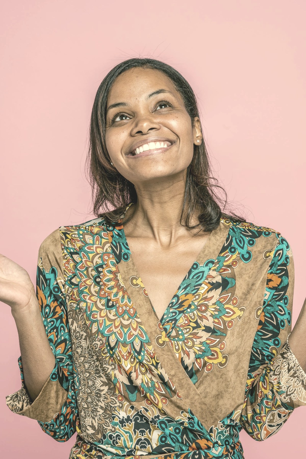 Confident woman in midlife smiling — GLP-1 medications help with menopausal weight gain, and the interaction with HRT matters