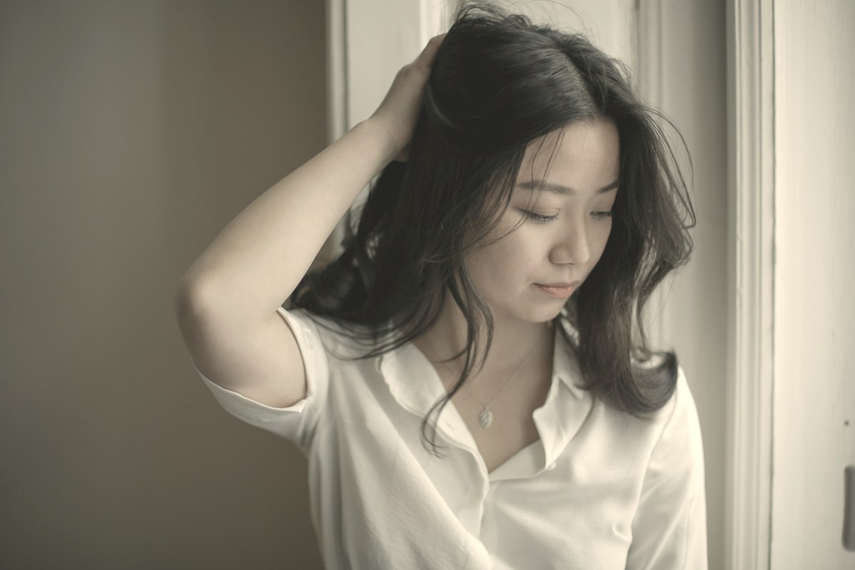 A calm person resting near a softly lit window, illustrating the slow, steady weeks-long timeline of Ozempic weight-loss results