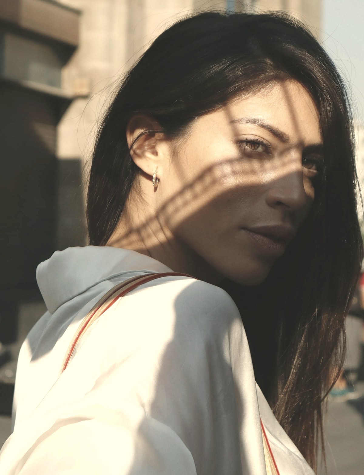 Close-up of a woman's face in natural light showing cheek and jawline contour — facial fat loss from GLP-1s concentrates in the superficial cheek compartments