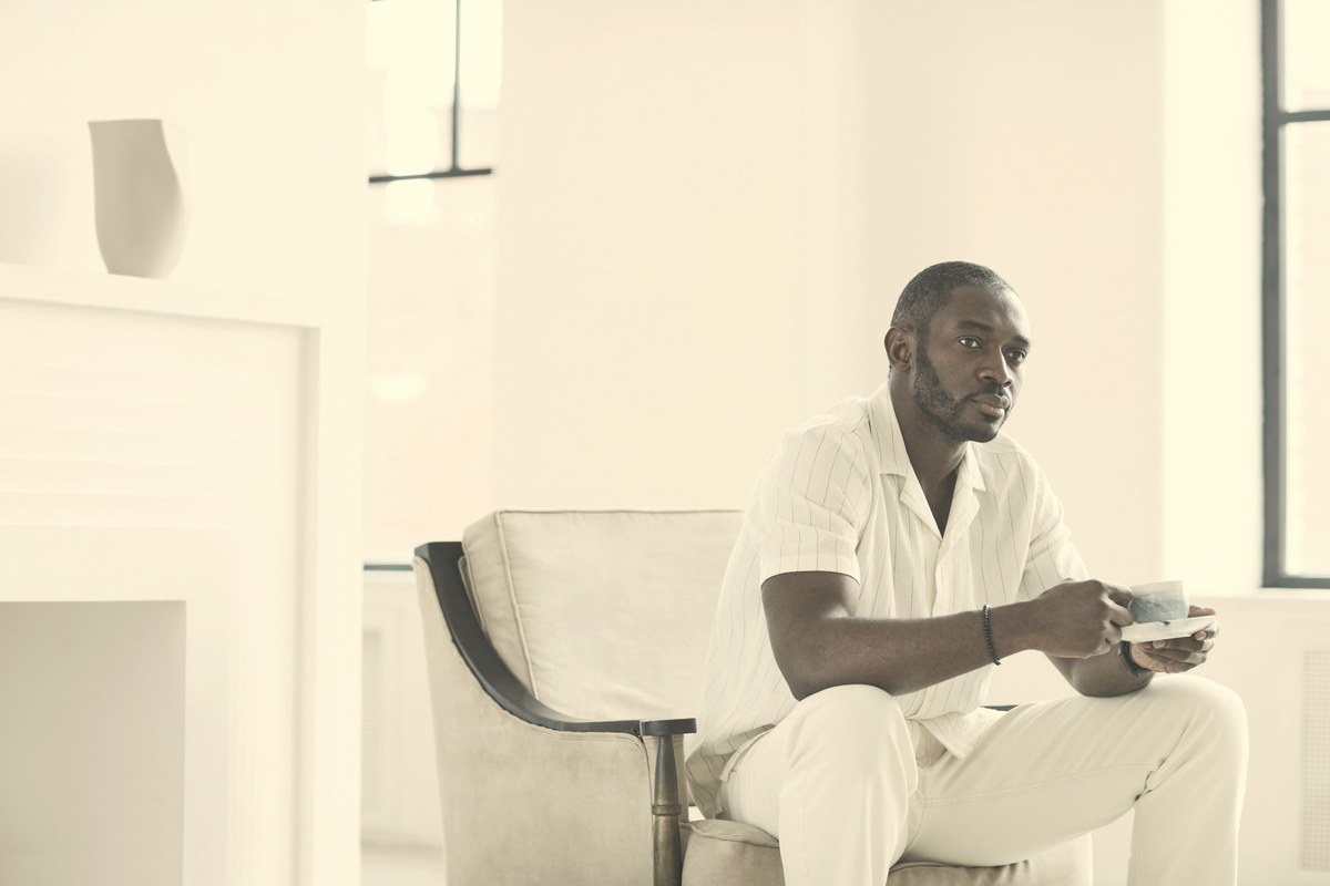 A man seated quietly in soft daylight against a muted background, reflecting the mixed, personal nature of erectile and hormonal changes on semaglutide.