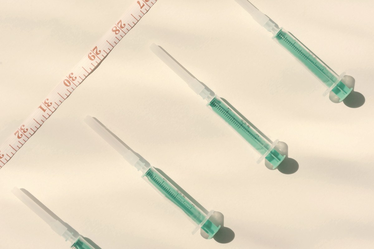 Syringes and measuring tape — illustrating tirzepatide dose measurement